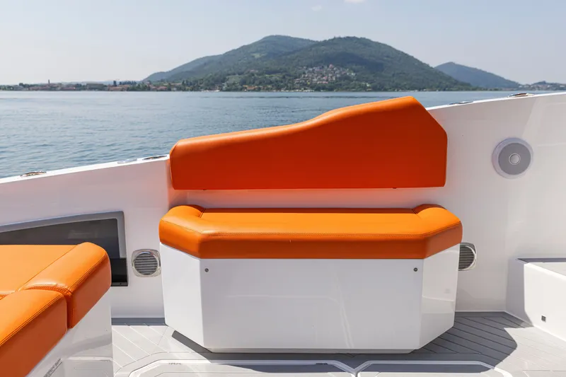 Slide: The Image of 2024 Rio Yachts Daytona 35 with orange seating, scenic mountain and lake view. - 26