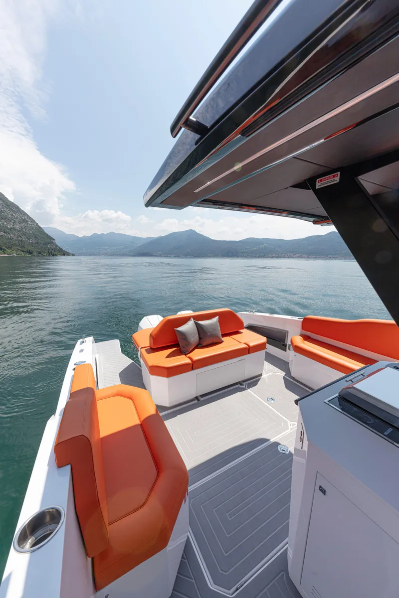 Slide: The Image of 2024 Rio Yachts Daytona 35 with orange seating, cruising on a serene lake. - 27