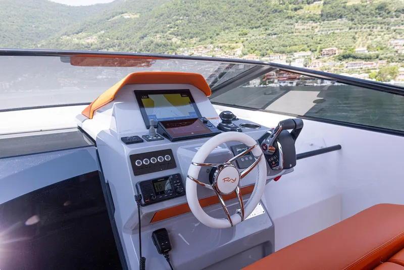 Slide: The Image of 2024 Rio Yachts Daytona 35 helm with modern controls and scenic background. - 28