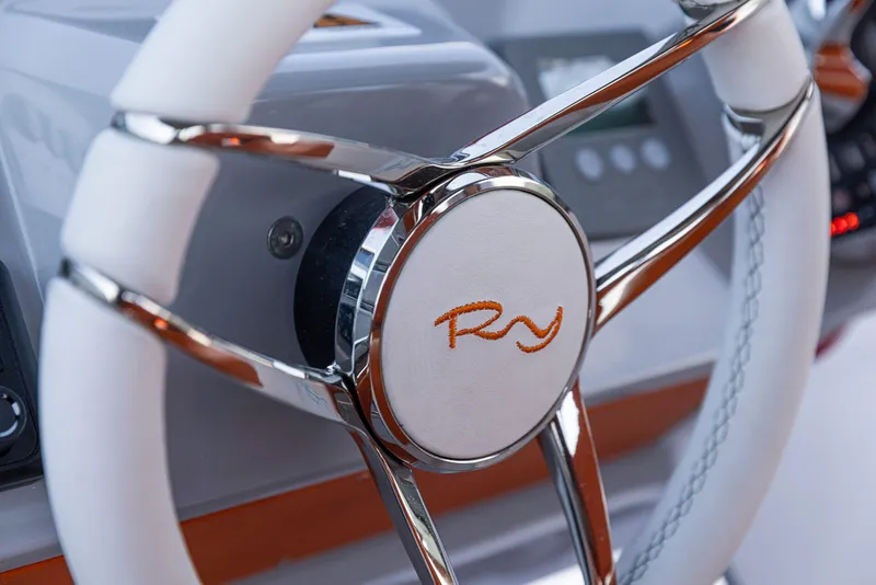 Slide: The Image of 2024 Rio Yachts Daytona 35 steering wheel, featuring sleek chrome and white design. - 29