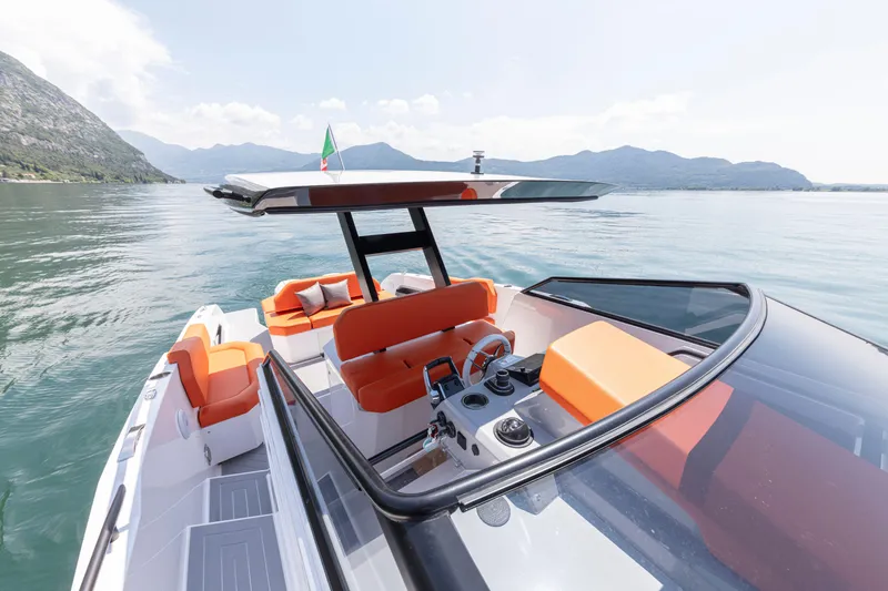 Slide: The Image of 2024 Rio Yachts Daytona 35 on serene water, featuring sleek design and vibrant orange seating. - 30