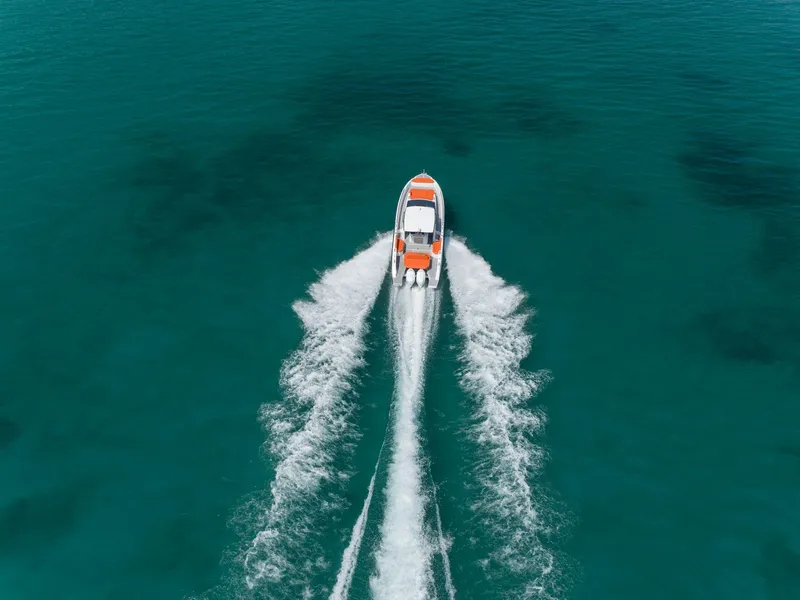 Slide: The Image of 2024 Rio Yachts Daytona 35 cruising on clear turquoise water, aerial view. - 6