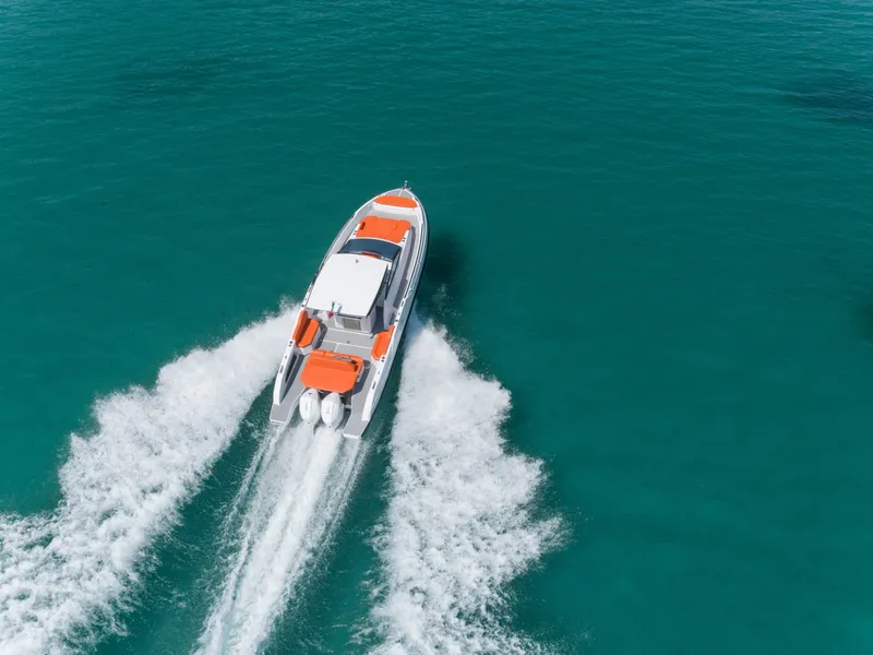 Slide: The Image of 2024 Rio Yachts Daytona 35 cruising on turquoise water, aerial view. - 7