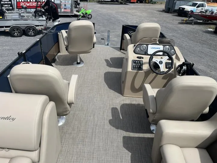 Slide: The Image of 2024 Bentley Pontoons Fish 203 Center Walk-Thru 3/4 Tube interior with beige seating and control console. - 16
