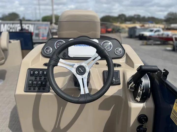 Slide: The Image of 2024 Bentley Pontoons Fish 203 Center Walk-Thru 3/4 Tube helm with steering wheel and controls. - 17