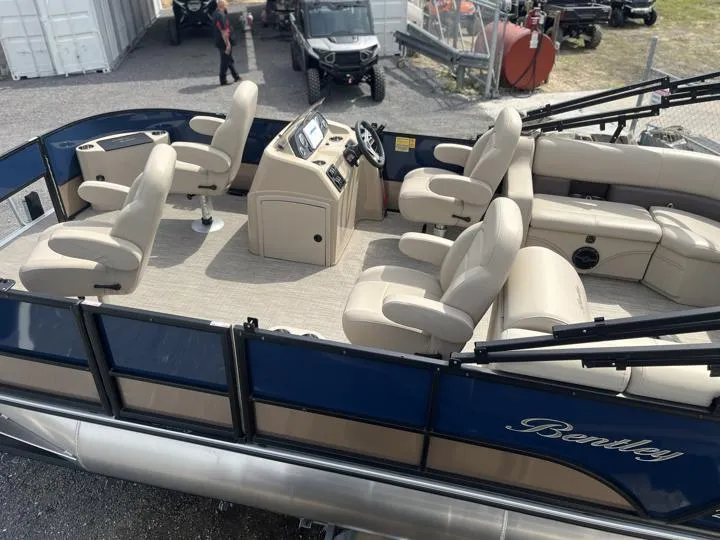 Slide: The Image of 2024 Bentley Pontoons Fish 203 Center Walk-Thru 3/4 Tube, beige seating, blue exterior. - 3