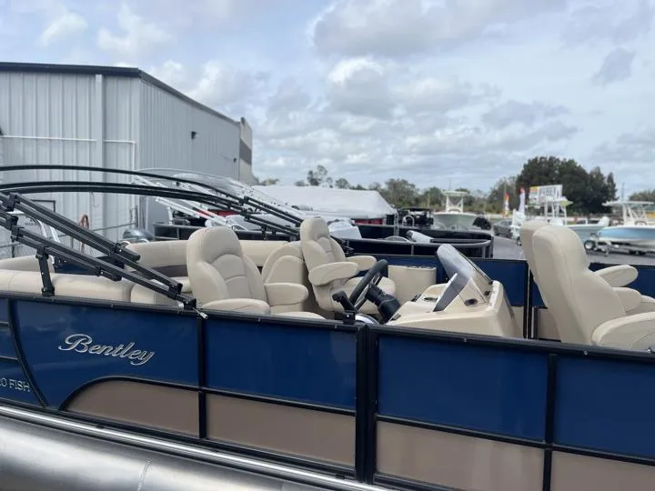 Slide: The Image of 2024 Bentley Pontoons Fish 203 Center Walk-Thru 3/4 Tube, blue and beige, docked. - 6