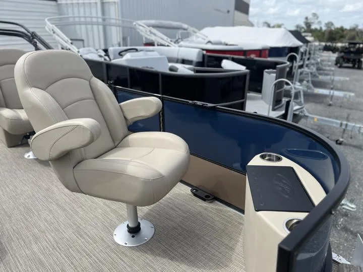 Slide: The Image of 2024 Bentley Pontoons Fish 203 Center Walk-Thru 3/4 Tube, beige captain's chair, docked. - 9