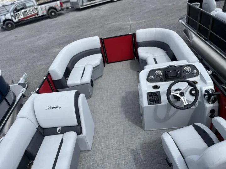 Slide: The Image of 2024 Bentley Pontoons LE 160 CR interior with plush seating and modern helm. - 14