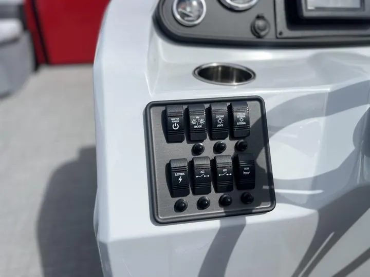 Slide: The Image of Control panel of 2024 Bentley Pontoons LE 160 CR boat with various switches. - 16
