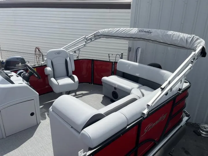 Slide: The Image of 2024 Bentley Pontoons LE 160 CR interior with red and gray seating. - 4