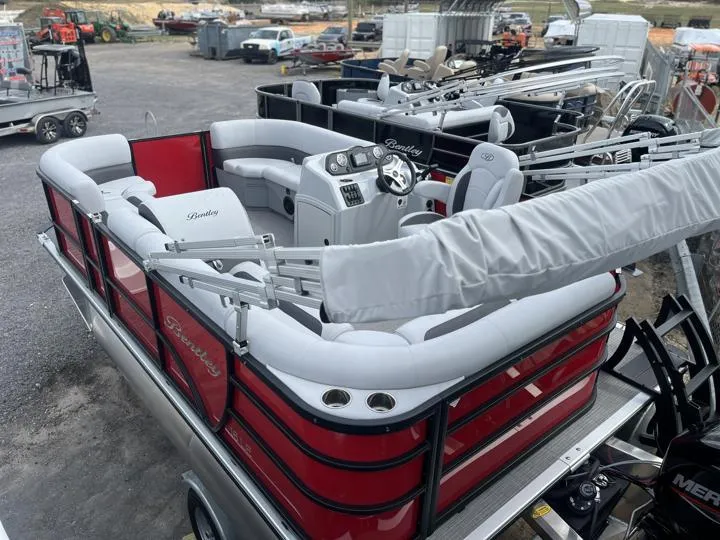 Slide: The Image of 2024 Bentley Pontoons LE 160 CR, red and white luxury pontoon boat, docked at marina. - 5