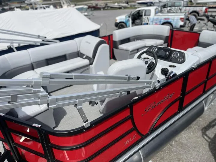 Slide: The Image of 2024 Bentley Pontoons LE 160 CR with red exterior and spacious seating. - 6