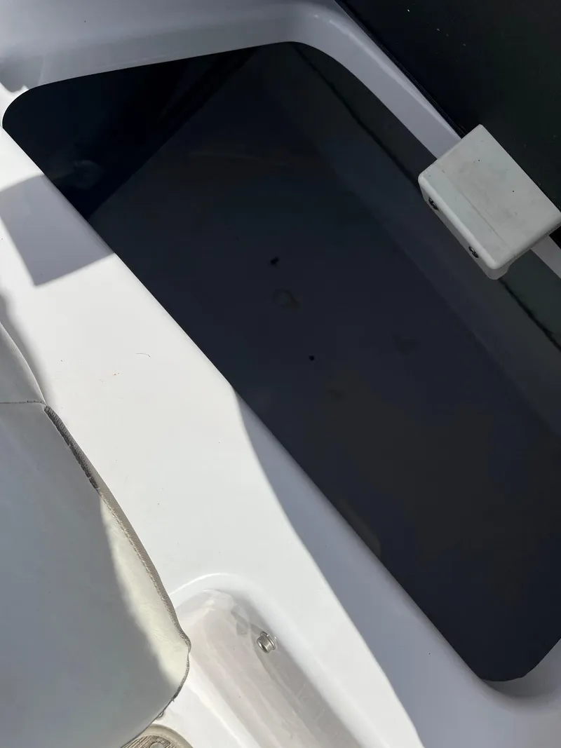 Slide: The Image of 2018 Glastron GTD storage compartment. - 13