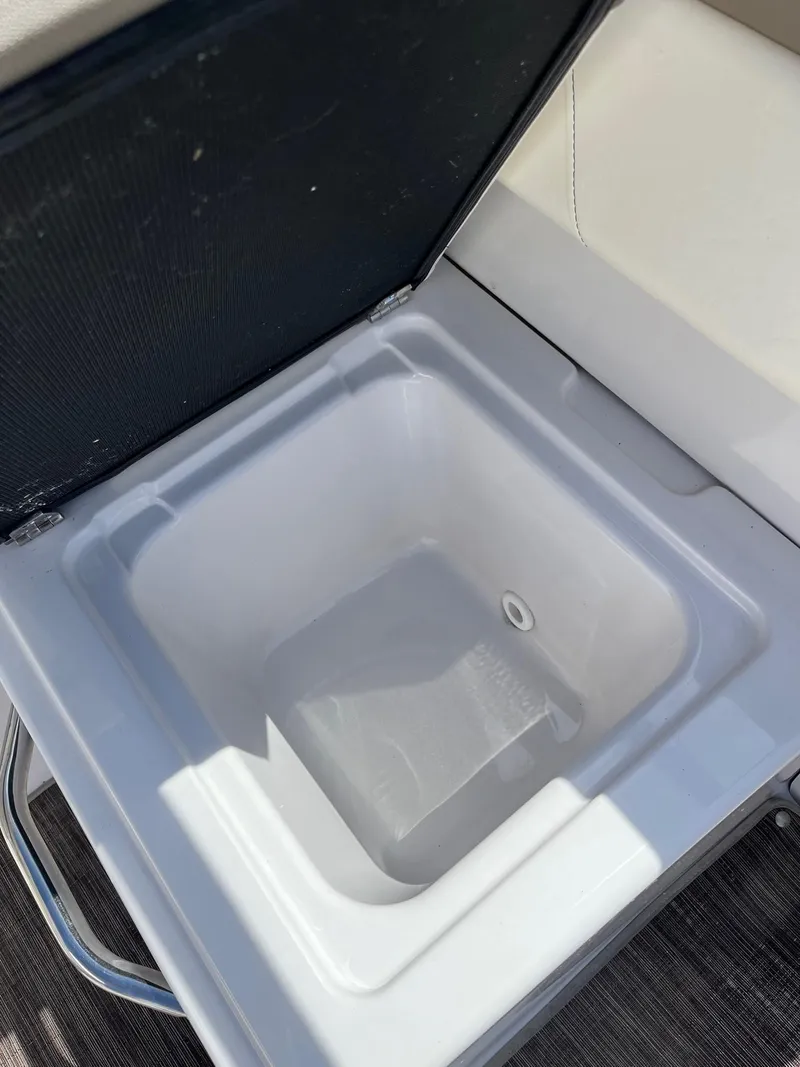 Slide: The Image of Built-in cooler compartment on a 2018 Glastron GTD boat. - 14