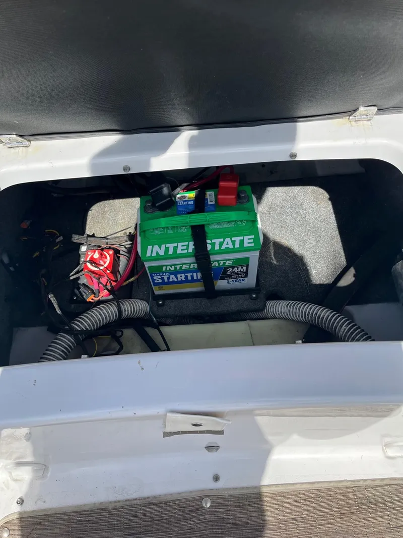 Slide: The Image of 2018 Glastron GTD boat battery compartment with Interstate marine battery. - 15
