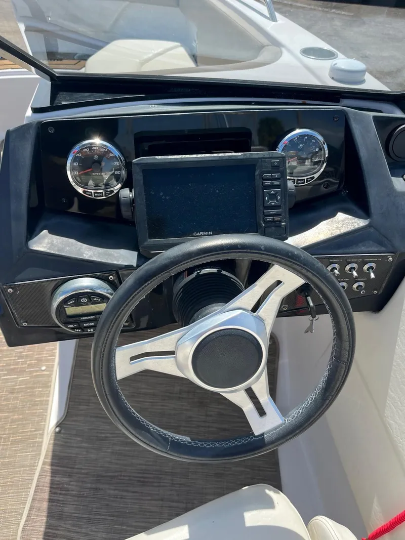 Slide: The Image of 2018 Glastron GTD boat dashboard with steering wheel and navigation system. - 4
