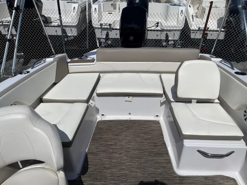 Slide: The Image of 2018 Glastron GTD boat interior with white seating and wood flooring. - 6