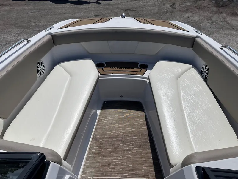 Slide: The Image of 2018 Glastron GTD boat interior with white cushioned seating and wood flooring. - 7