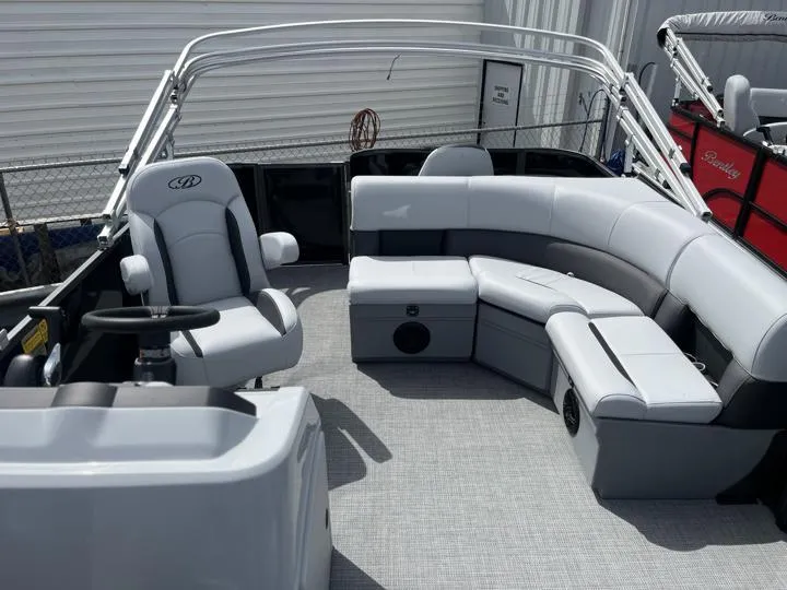Slide: The Image of 2024 Bentley Pontoons LE 180 3 PT interior with gray seating and steering console. - 15