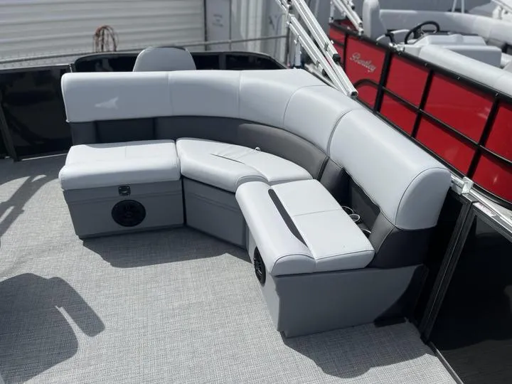Slide: The Image of 2024 Bentley Pontoons LE 180 3 PT interior seating area with gray upholstery. - 16