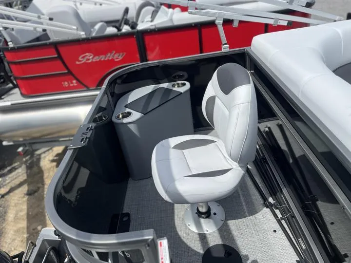 Slide: The Image of 2024 Bentley Pontoons LE 180 3 PT interior with captain's chair and console. - 18