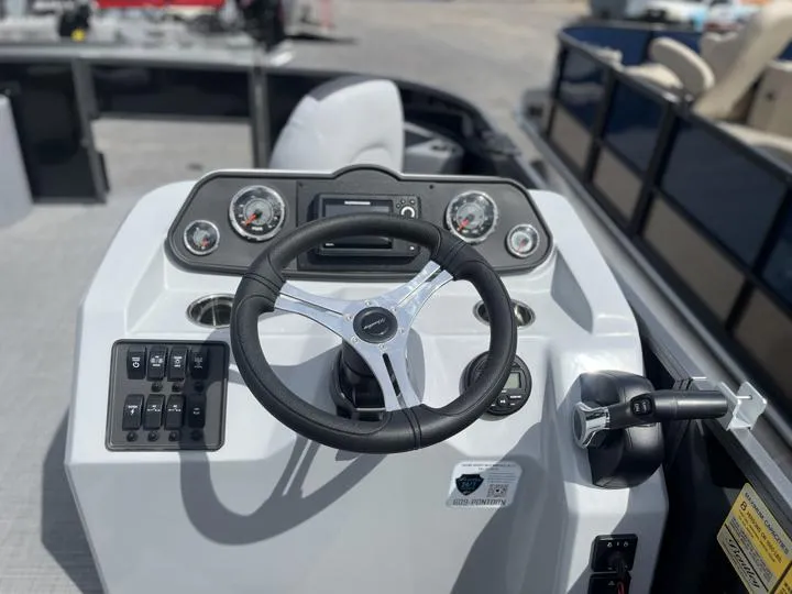 Slide: The Image of 2024 Bentley Pontoons LE 180 3 PT boat dashboard with steering wheel and control panel. - 20