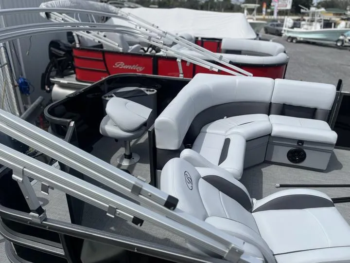 Slide: The Image of 2024 Bentley Pontoons LE 180 3 PT interior with white seating and helm station. - 8