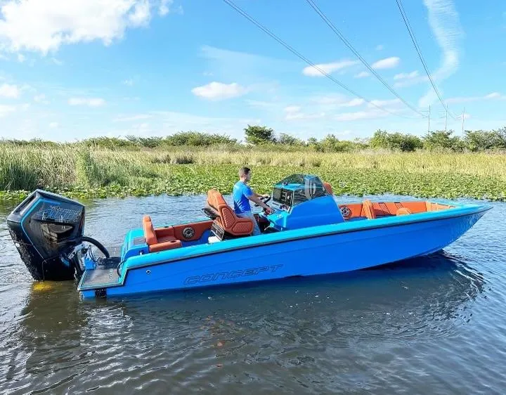 Slide: The Image of 2024 Concept 27' CC boat in blue on a calm waterway. - 1