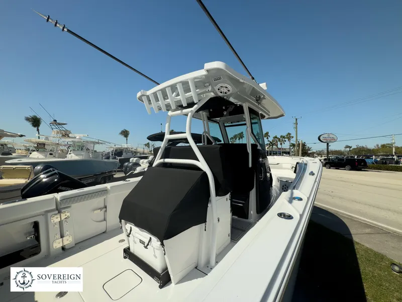 Slide: The Image of 2024 Blackfin 302CC center console boat at Sovereign Yachts dealership. - 13