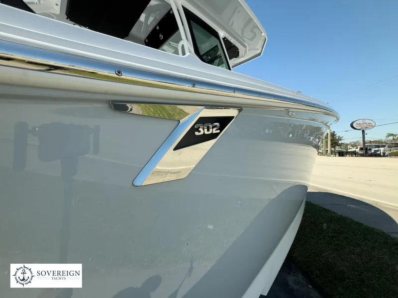 Slide: The Image of 2024 Blackfin 302CC boat side view with Sovereign Yachts logo. - 14