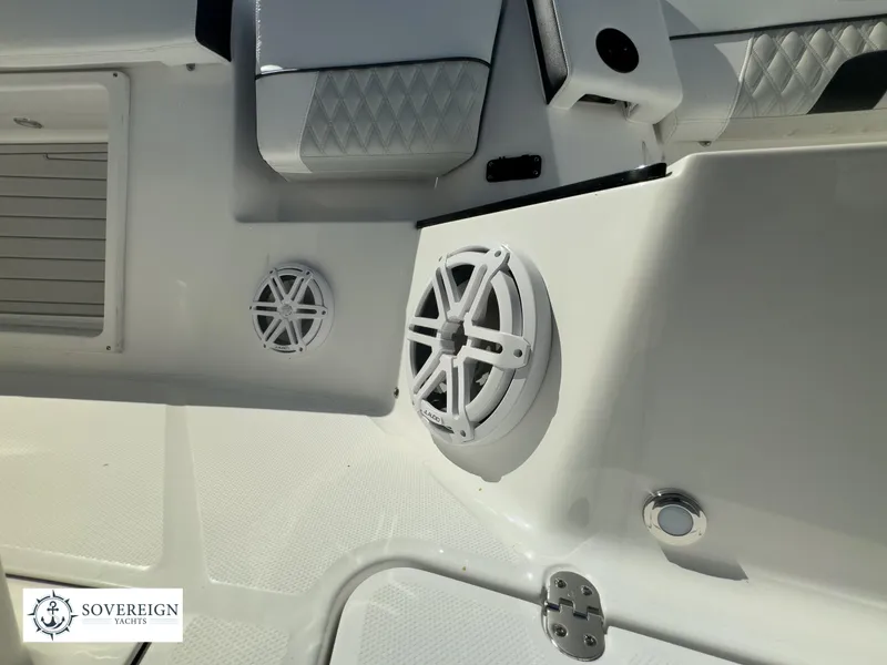 Slide: The Image of Close-up of the 2024 Blackfin 302CC boat interior with speakers and seating. - 20