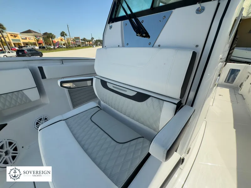 Slide: The Image of 2024 Blackfin 302CC boat interior with white cushioned seating. - 24
