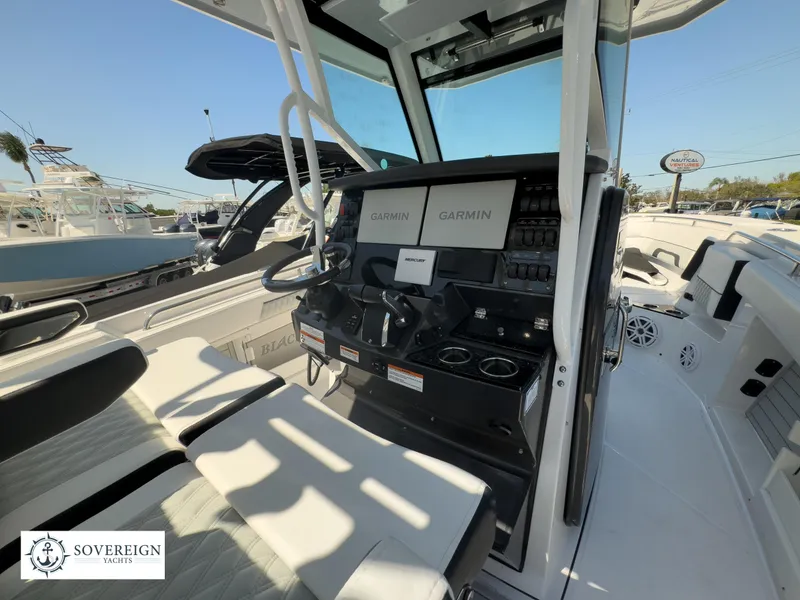 Slide: The Image of 2024 Blackfin 302CC boat interior with Garmin navigation system and seating. - 27