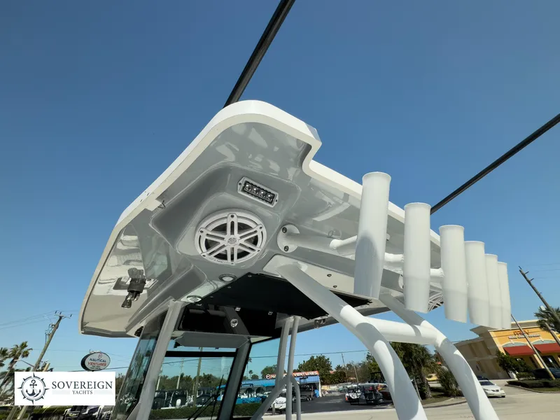 Slide: The Image of 2024 Blackfin 302CC boat with overhead rod holders and speaker system. - 37