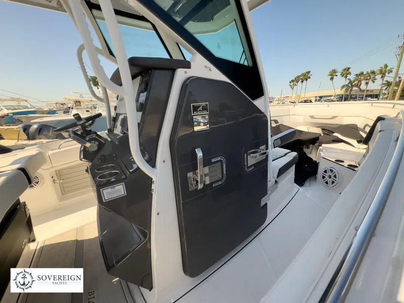 Slide: The Image of 2024 Blackfin 302CC boat interior with helm station and seating area. - 38