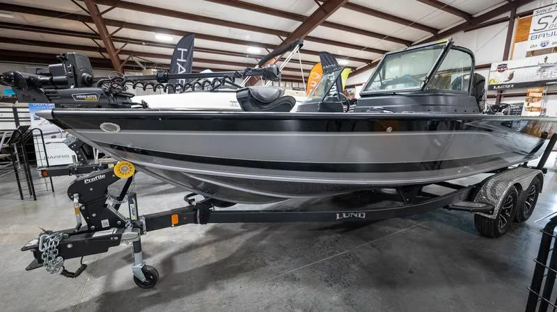 The Image of 2024 Lund 2025 Impact XS Sport boat on display in a showroom. - 1