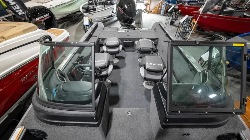 Slide: The Image of 2024 Lund 2025 Impact XS Sport boat interior with seating and windshield. - 10