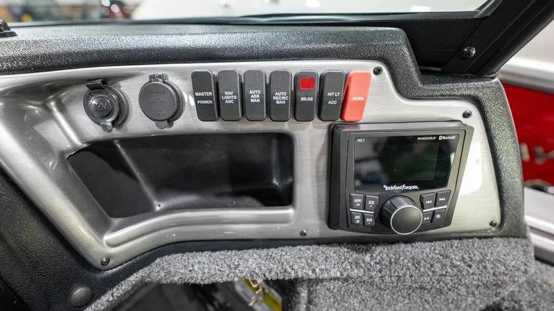 Slide: The Image of Control panel of 2024 Lund 2025 Impact XS Sport boat with switches and Rockford Fosgate stereo. - 14