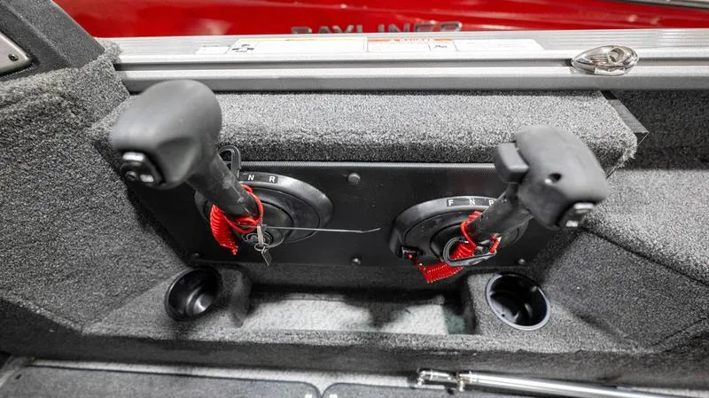 Slide: The Image of 2024 Lund 2025 Impact XS Sport boat control levers in cockpit. - 16
