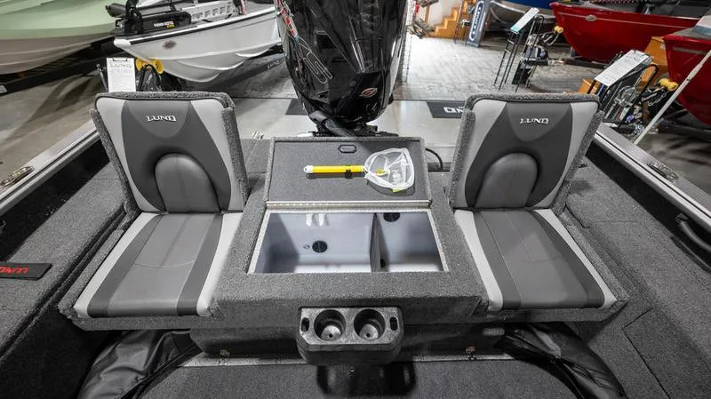 Slide: The Image of 2024 Lund 2025 Impact XS Sport boat interior with seating and storage compartments. - 19