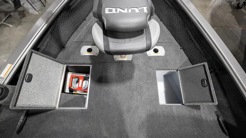 Slide: The Image of 2024 Lund 2025 Impact XS Sport boat interior with storage compartments and seating. - 5