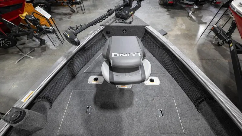 Slide: The Image of 2024 Lund 2025 Impact XS Sport boat interior with seating and fishing equipment. - 6