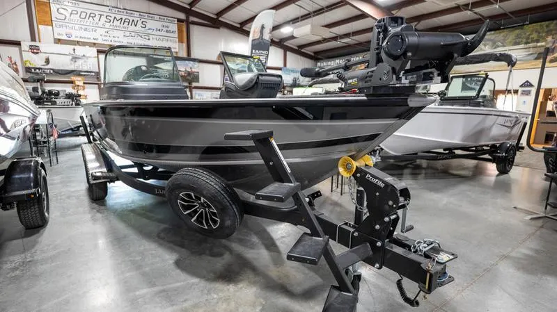 Slide: The Image of 2024 Lund 2025 Impact XS Sport fishing boat on display in showroom. - 7