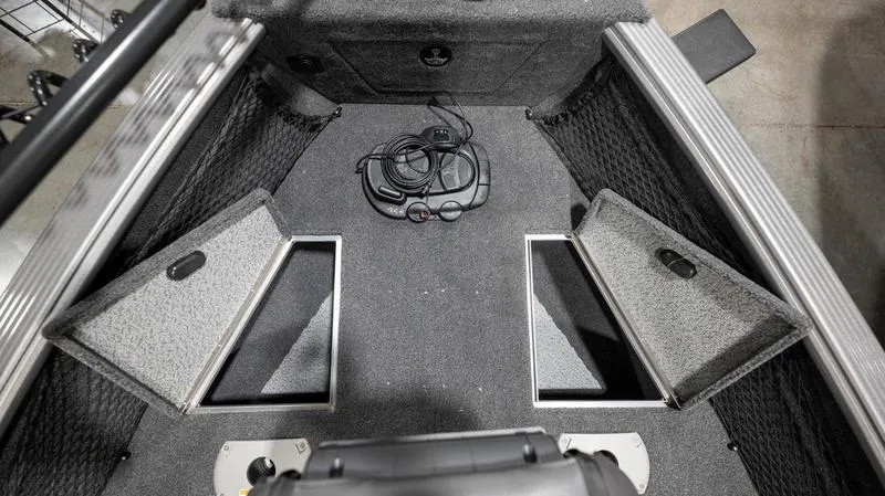 Slide: The Image of 2024 Lund 2025 Impact XS Sport boat interior storage compartments. - 8