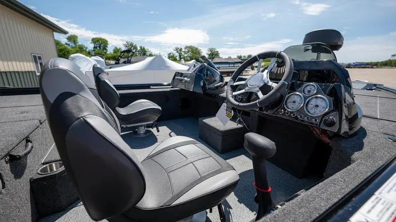 Slide: The Image of 2024 Lund 1875 Pro-V Bass XS boat interior with steering console and seating. - 11
