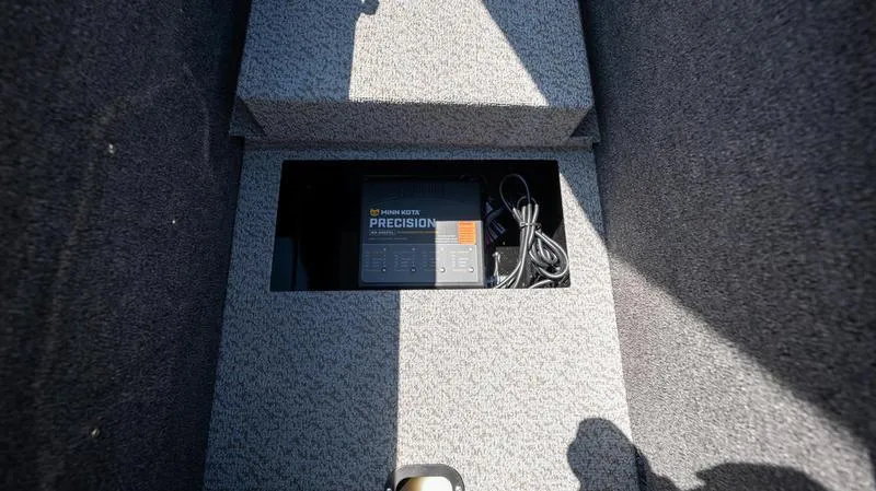 Slide: The Image of 2024 Lund 1875 Pro-V Bass XS storage compartment with Precision charger. - 18