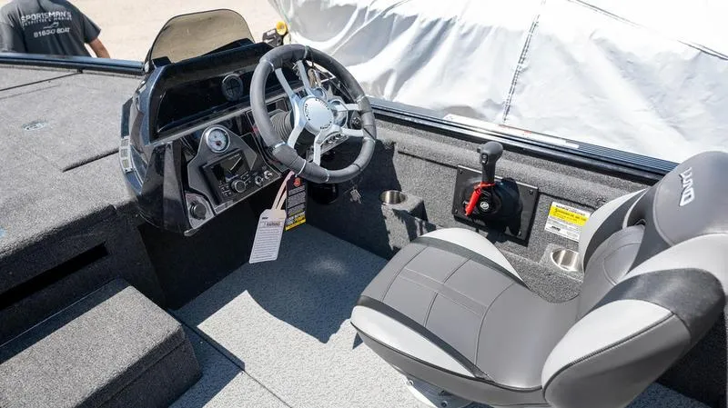Slide: The Image of 2024 Lund 1875 Pro-V Bass XS boat interior with steering wheel and captain's chair. - 22