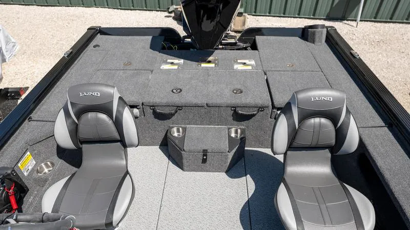 Slide: The Image of 2024 Lund 1875 Pro-V Bass XS boat interior with two seats and storage compartments. - 23