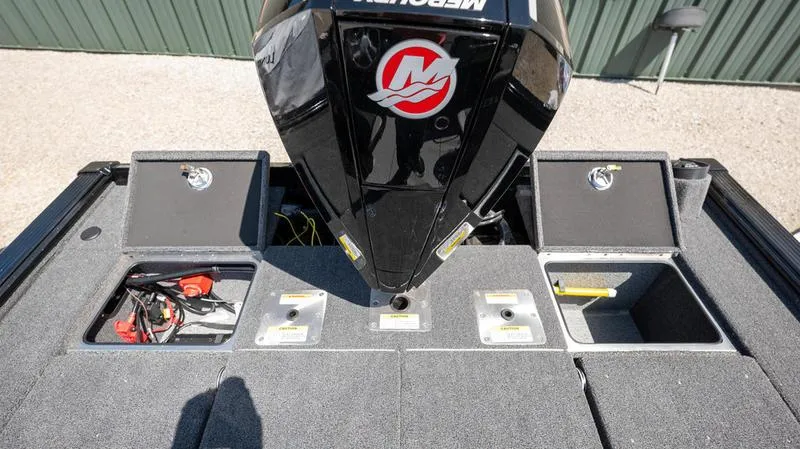 Slide: The Image of 2024 Lund 1875 Pro-V Bass XS boat with Mercury outboard motor and storage compartments. - 25